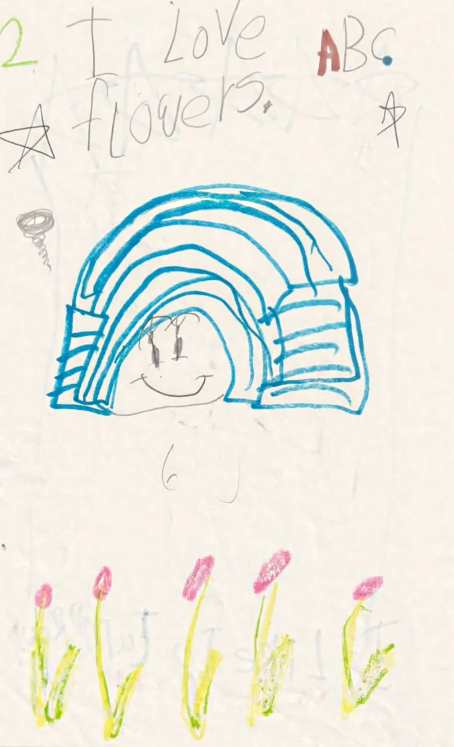 A childhood drawing of a rainbow with a face and tulips, captioned I love flowers