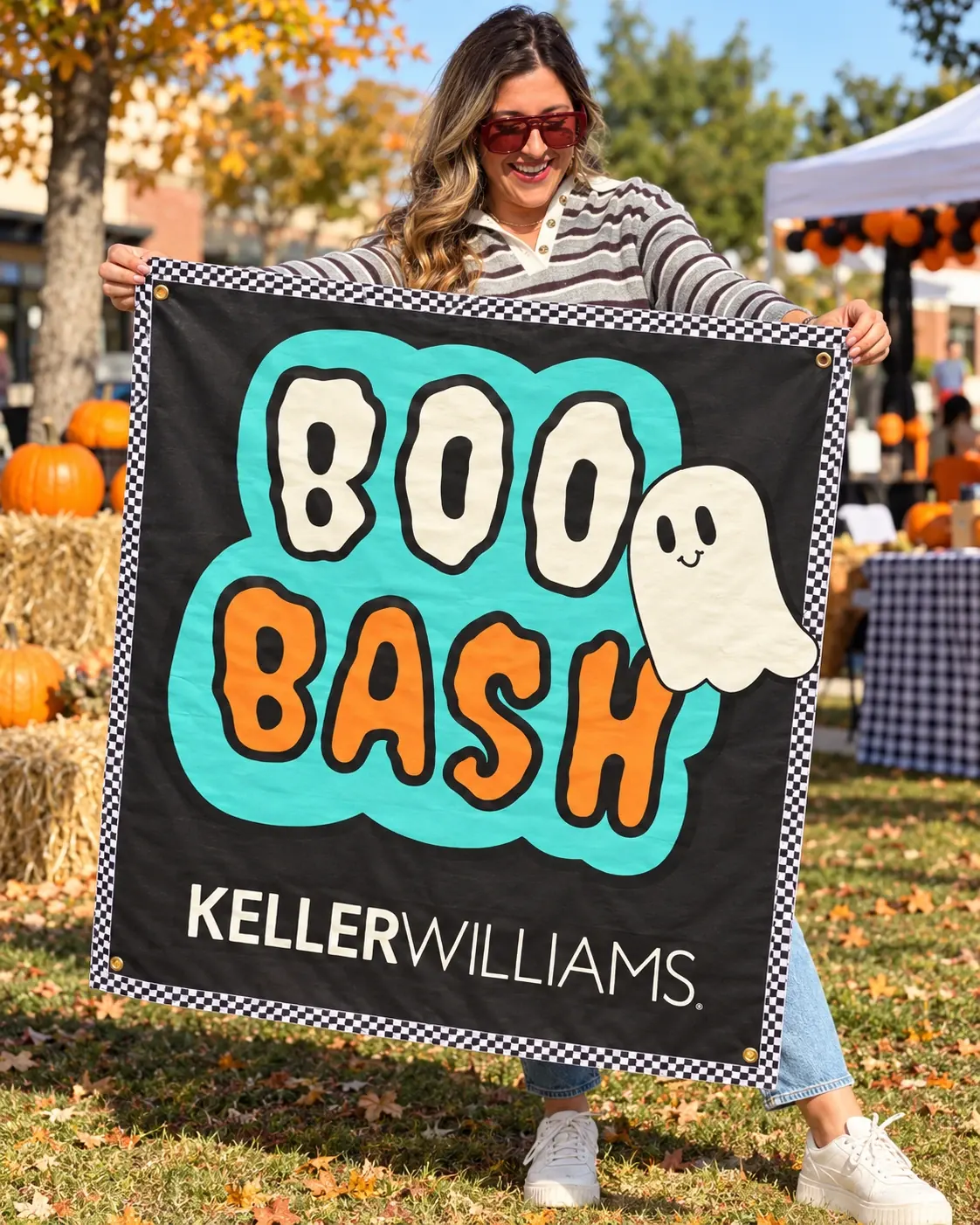 A customer holding the Boo Bash banner outdoors