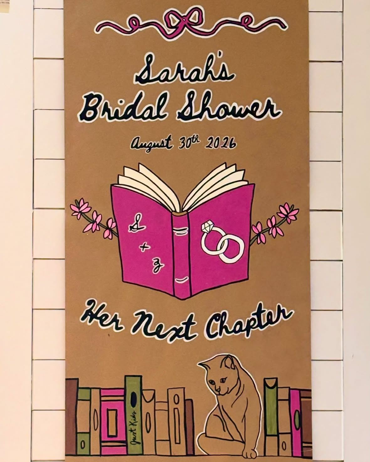 Hand-painted kraft banner reading Sarah's Bridal Shower, Her Next Chapter